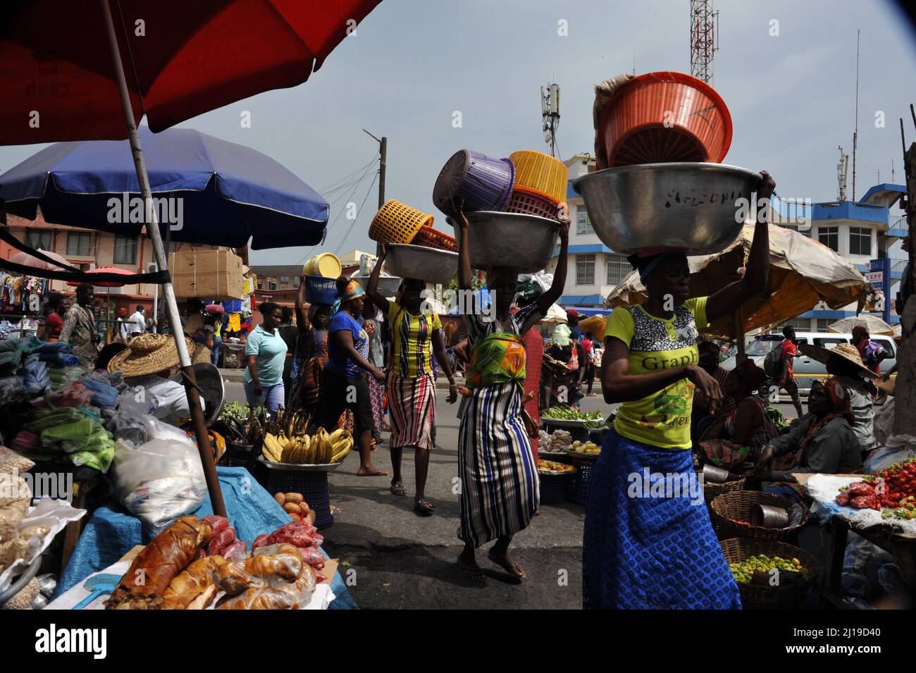 Accra, Ghana. 21st Mar, 2022. Vendors sell products in a busy street in