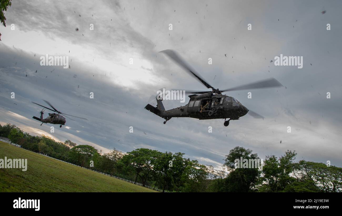 Two U.S. Army UH-60 Black Hawks, assigned to the 2nd Assault Helicopter Battalion, 25th Aviation Regiment, 25th Infantry Division, take-off for an air assault, Mar. 22, 2022, Fort Thanarat, Thailand. Air assaults allow troops to rapidly insert near an objective and utilize the element of surprise during the attack. (U.S. Air Force photo by Tech. Sgt. Michael Mason) Stock Photo