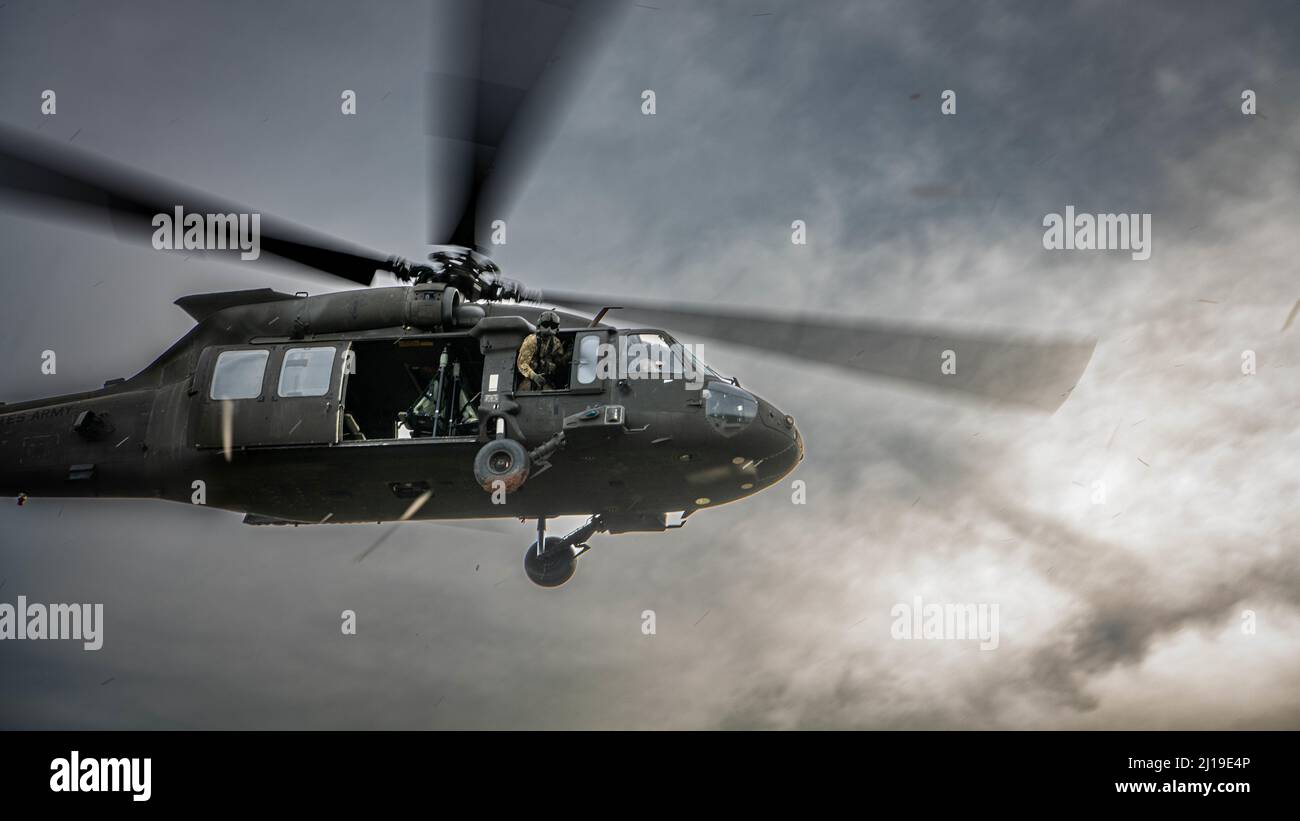 A U.S. Army UH-60 Black Hawks, assigned to the 2nd Assault Helicopter Battalion, 25th Aviation Regiment, 25th Infantry Division, takes-off during an air assault, Mar. 22, 2022, Fort Thanarat, Thailand. Air assaults allow troops to rapidly insert near an objective and utilize the element of surprise during the attack. (U.S. Air Force photo by Tech. Sgt. Michael Mason) Stock Photo