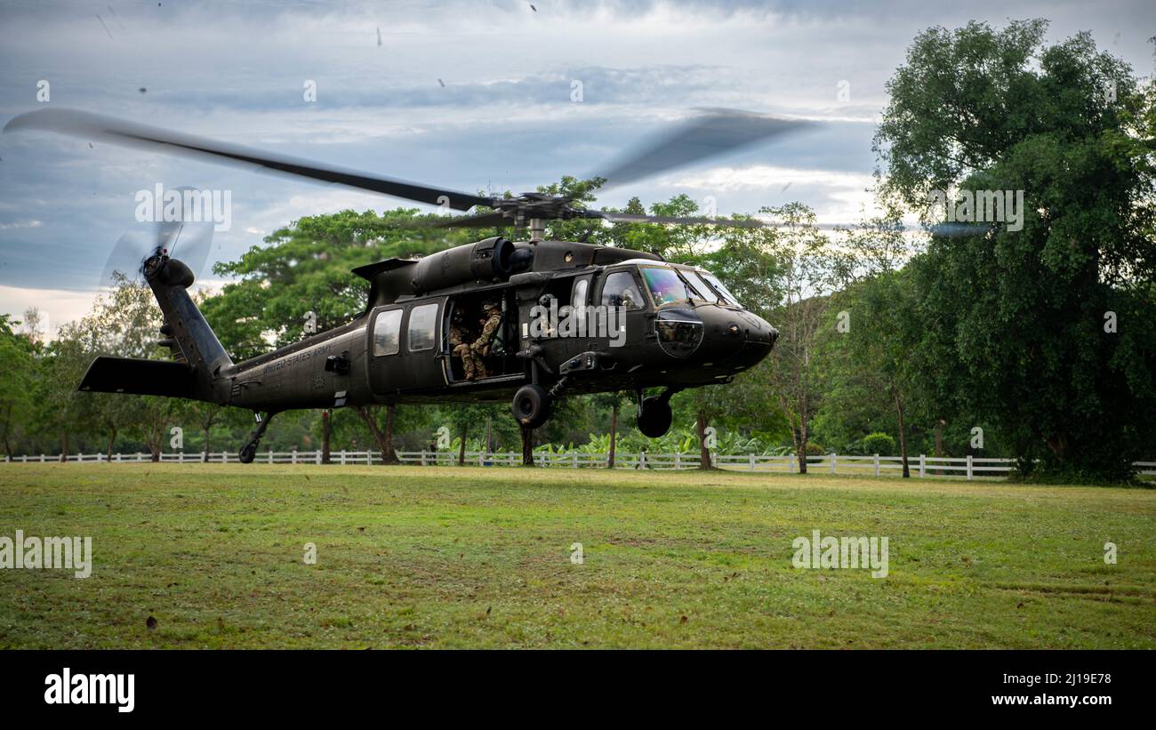 A U.S. Army UH-60 Black Hawk, assigned to the 2nd Assault Helicopter Battalion, 25th Aviation Regiment, 25th Infantry Division, takes-off for an air assault, Mar. 22, 2022, Fort Thanarat, Thailand. Air assaults allow troops to rapidly insert near an objective and utilize the element of surprise during the attack. (U.S. Air Force photo by Tech. Sgt. Michael Mason) Stock Photo