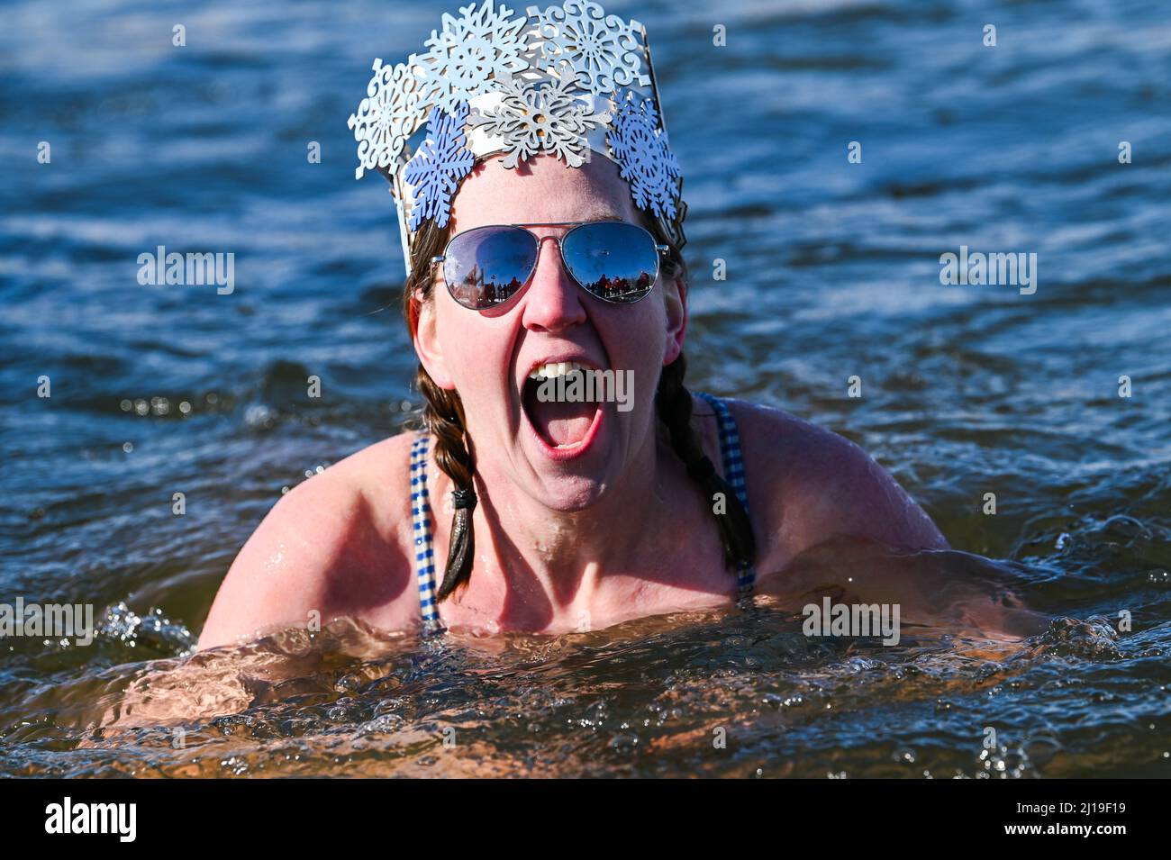 Cold water swimmers swim in the icy water of Lake Memphremagog near the
