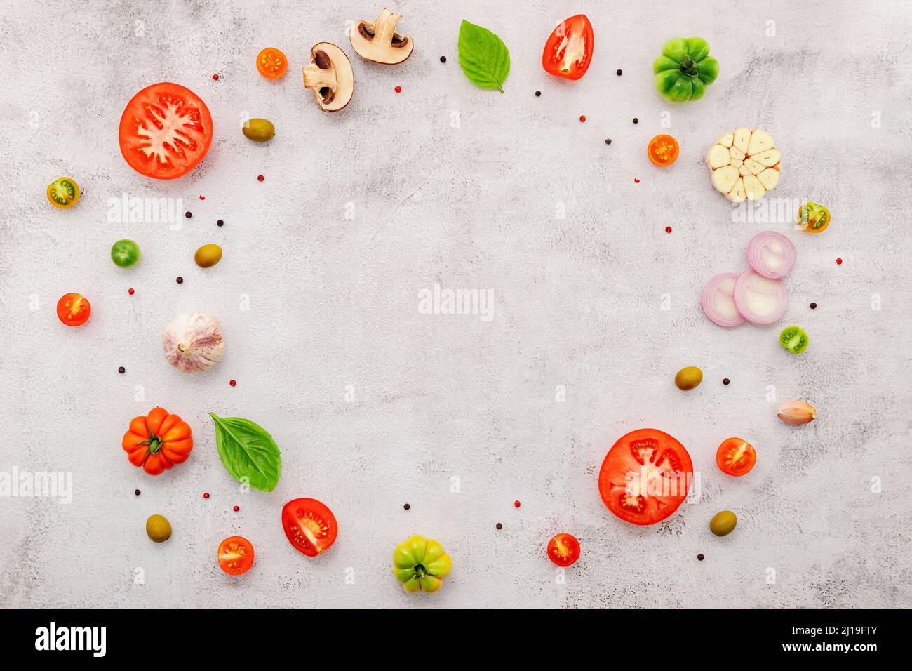 The ingredients for homemade pizza set up on white concrete background Stock Photo Alamy