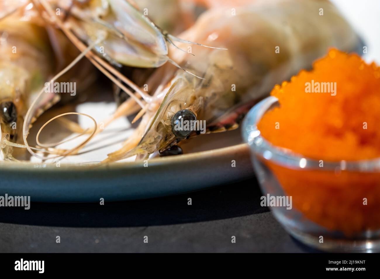 Focused on fresh Shrimp eye with blur tobiko beside. Stock Photo