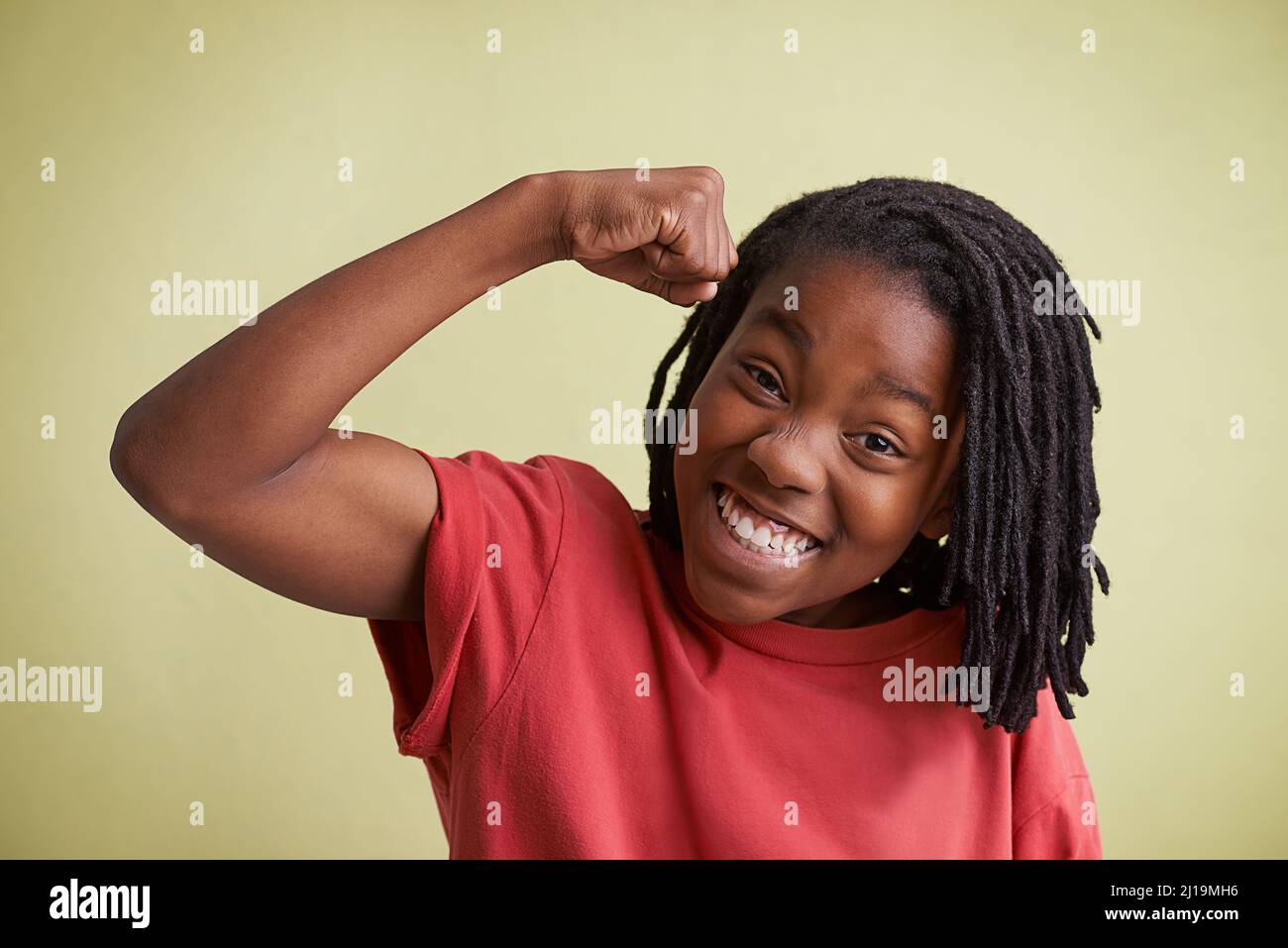 Check these muscles out. Studio portrait of a young boy showing off his muscles. Stock Photo