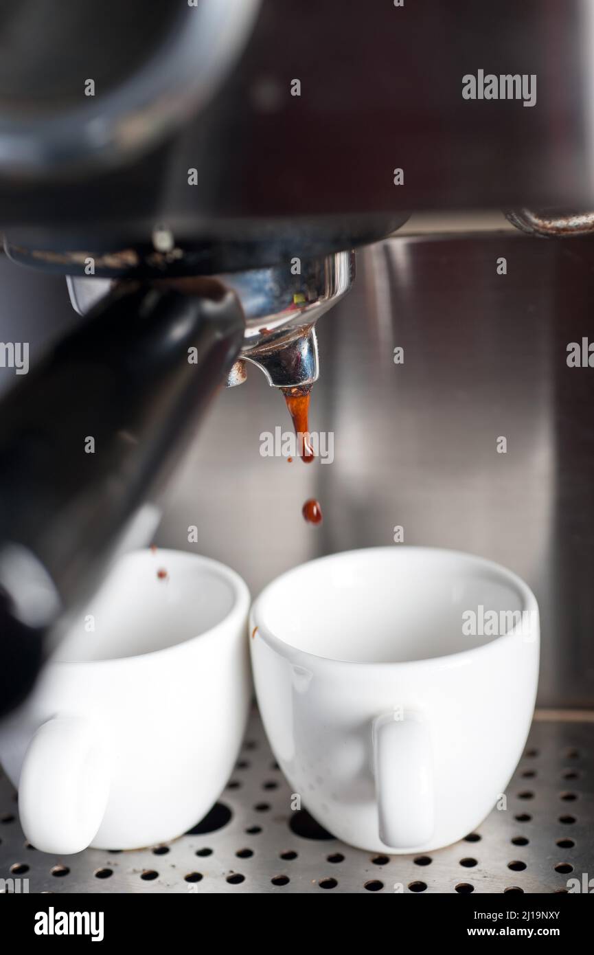Italian espresso coffe making with professional machine macro Stock Photo