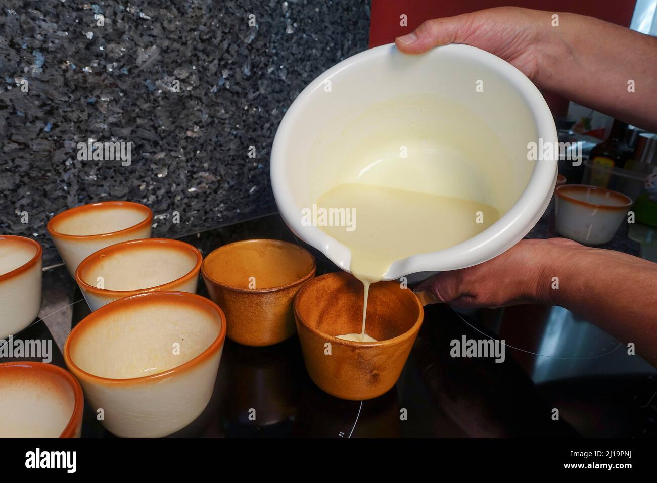 Swabian cuisine, preparing Pfitzauf, pouring dough into bowls, men's hands, mixing bowl, Germany, Europe Stock Photo