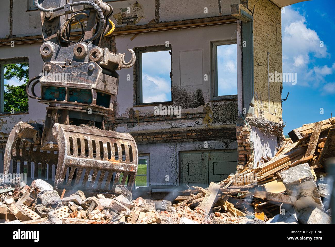 Debris in front of the wall of a demolished house, shovel of an excavator, Wolfhausen, Switzerland Stock Photo