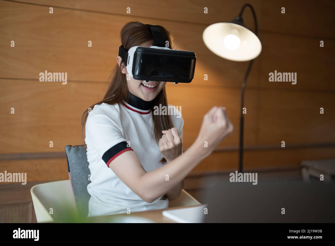 Photo of young asian woman cheerful guy have fun celebrate victory win game goggles ay her home Stock Photo