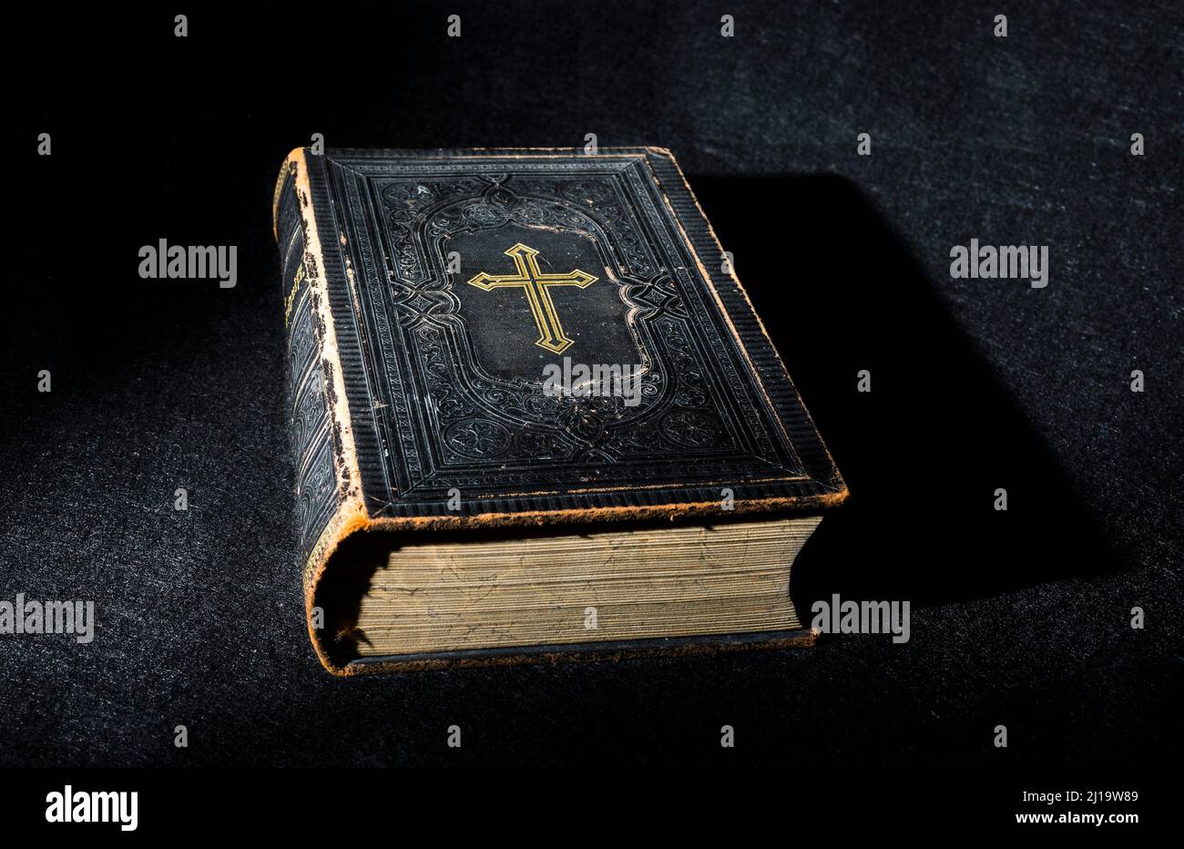 Old Bible, book on black background Stock Photo