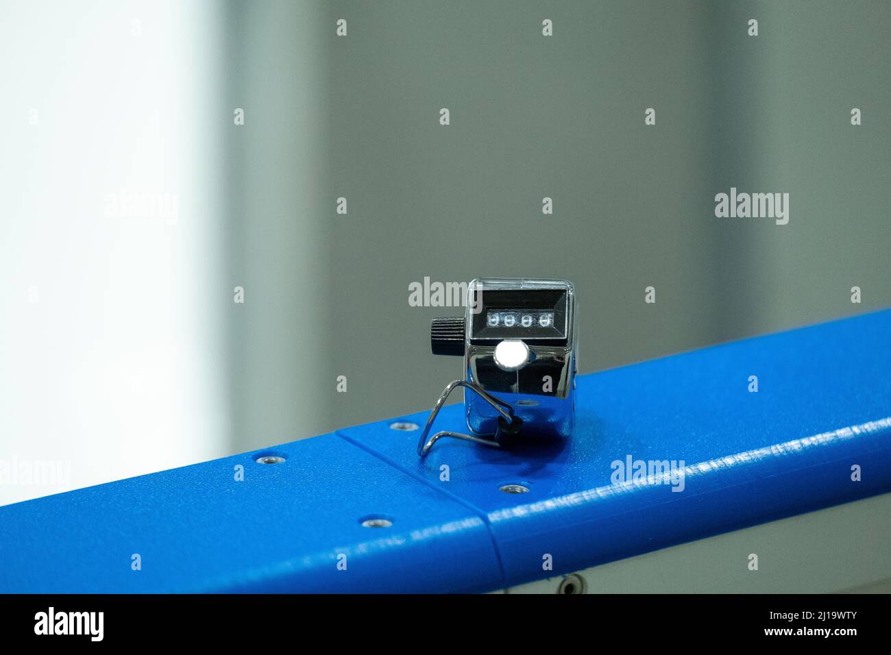 Closeup of a metallic click counter used by ice hockey officials to count shots on goal. Sports statistics. Stock Photo