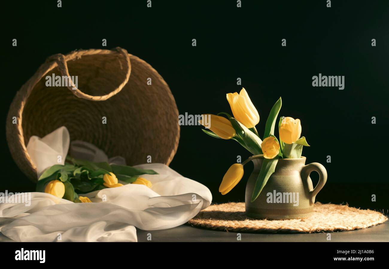 Still life with bouquet of yellow tulip flowers in old vintage jug, in ...