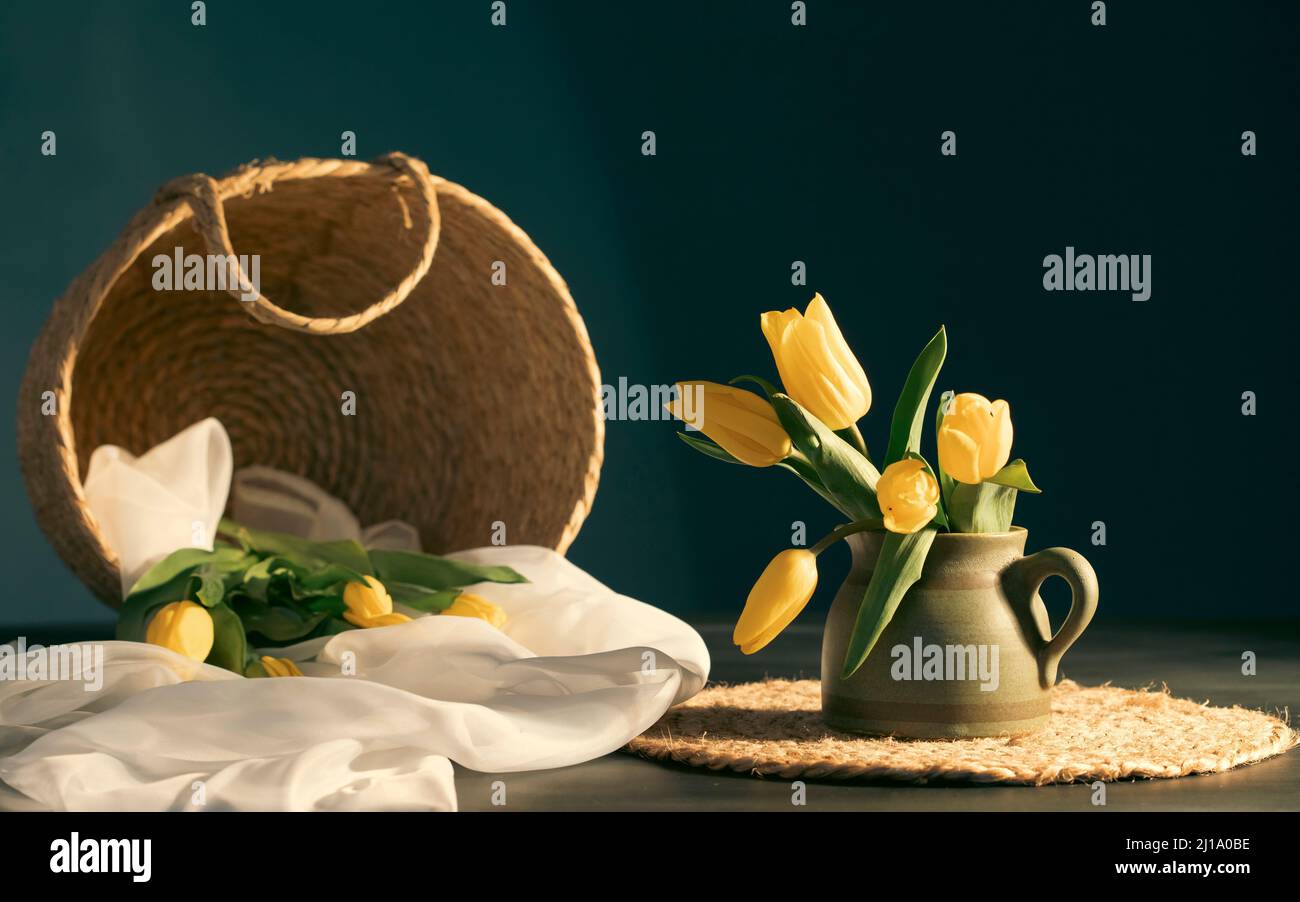 Still life with bouquet of yellow tulip flowers in old vintage jug, in ...