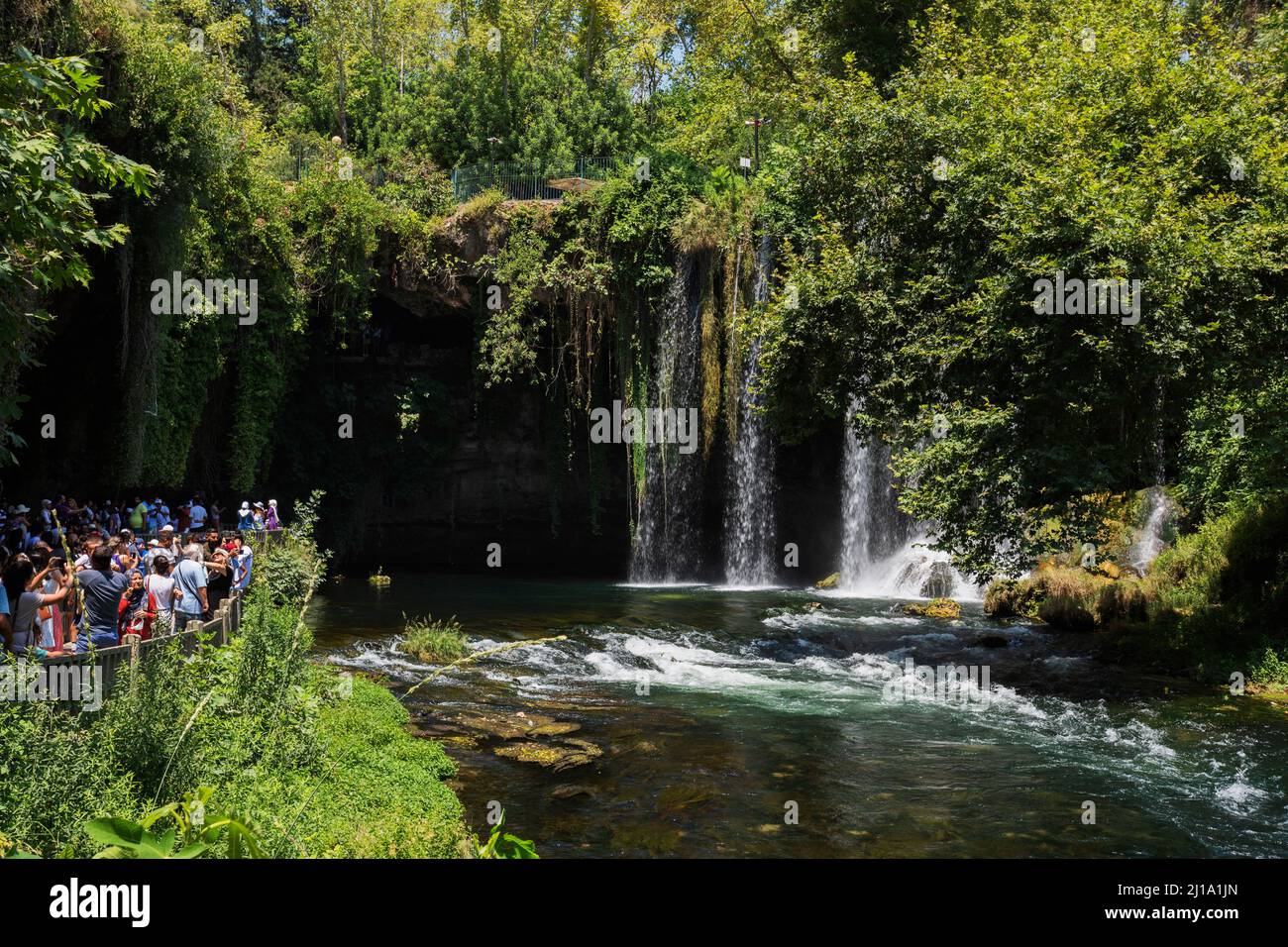 06-07-2022 Antalya Turkey. People are walking around Duden waterfall and taking pictures. Walking areas among the trees. Stock Photo