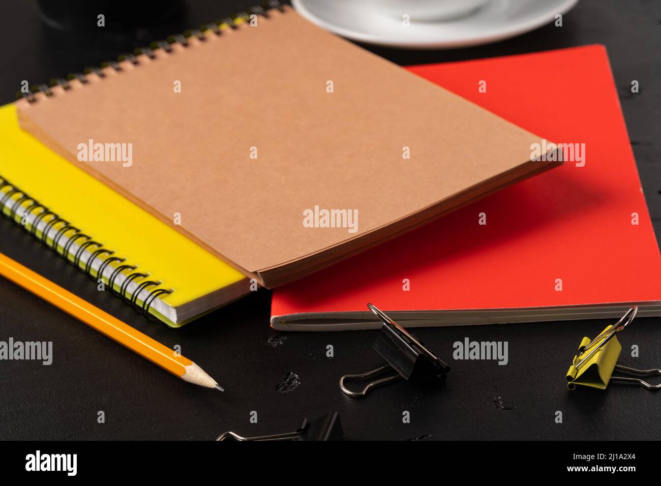 Three notepads on a black table close up Stock Photo