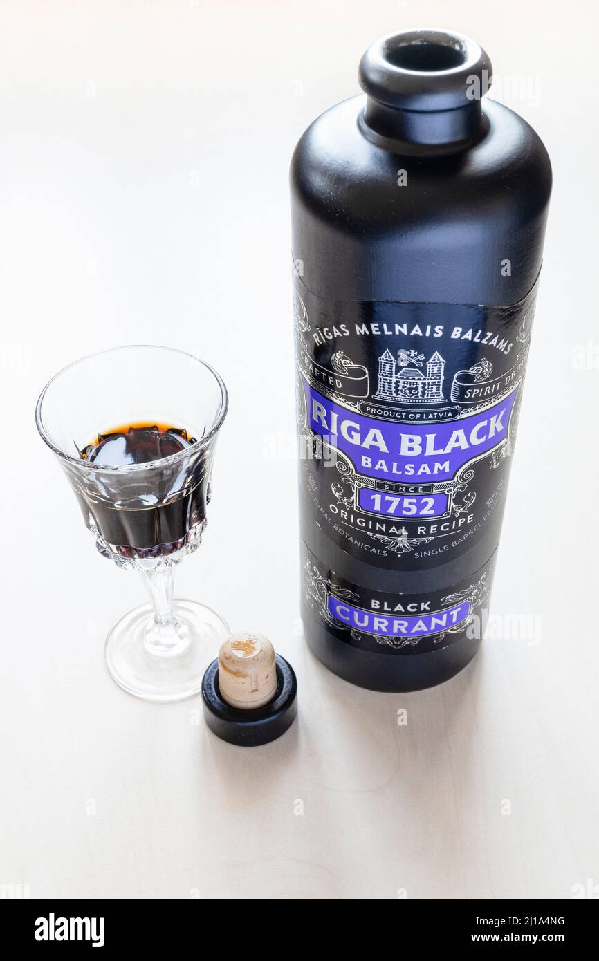 Moscow, Russia - March 20, 2022: glass and bottle of Riga Black Balsam on  pale table. Riga Black Balsam is probably the oldest bitter in the world,  th Stock Photo - Alamy