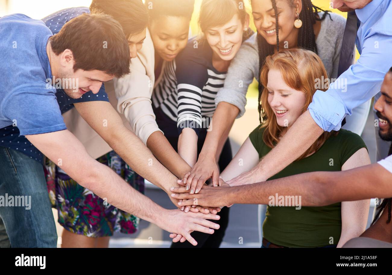 The team in high spirits. Shot of a group of people putting their hands together. Stock Photo