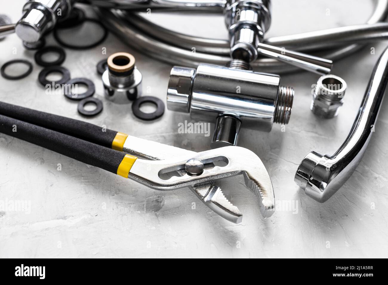 plumbing stilllife with wrench close up and disassembled shower faucet