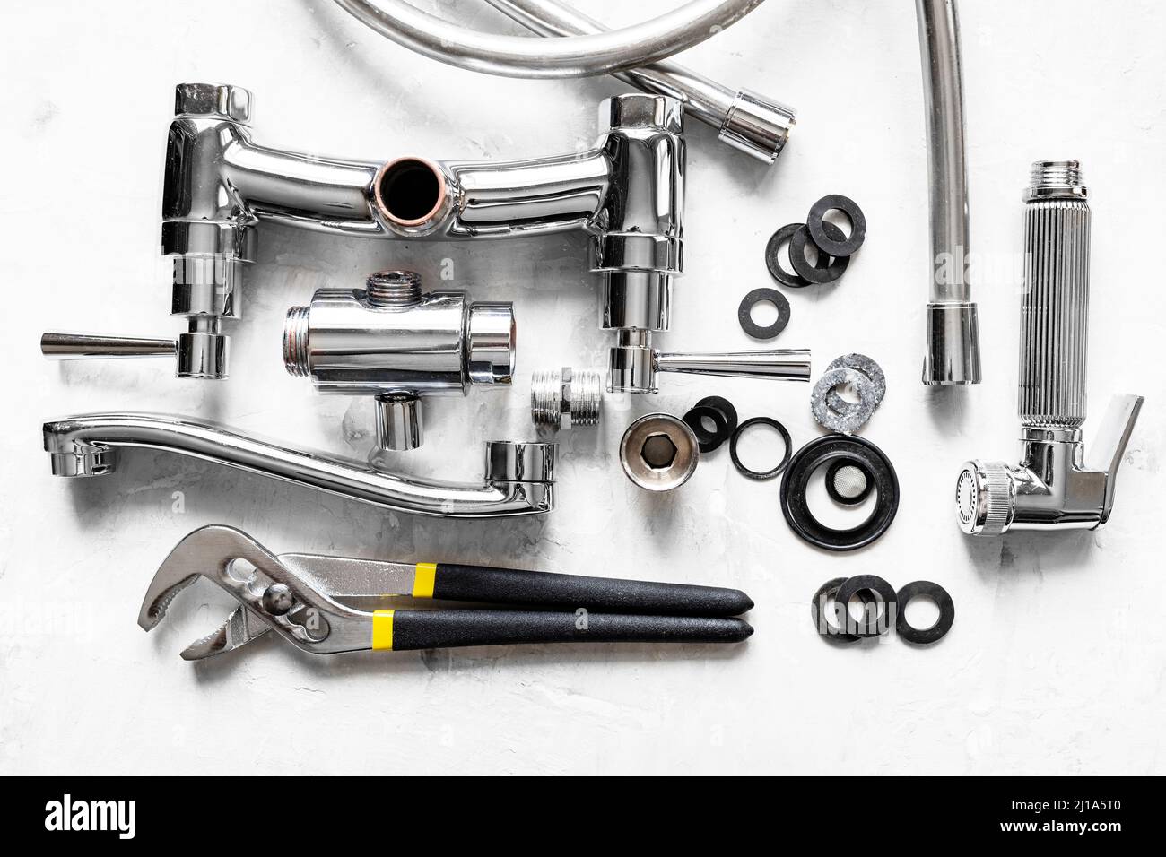 plumbing background above view of wrench, disassembled shower faucet valve, diverter, spout