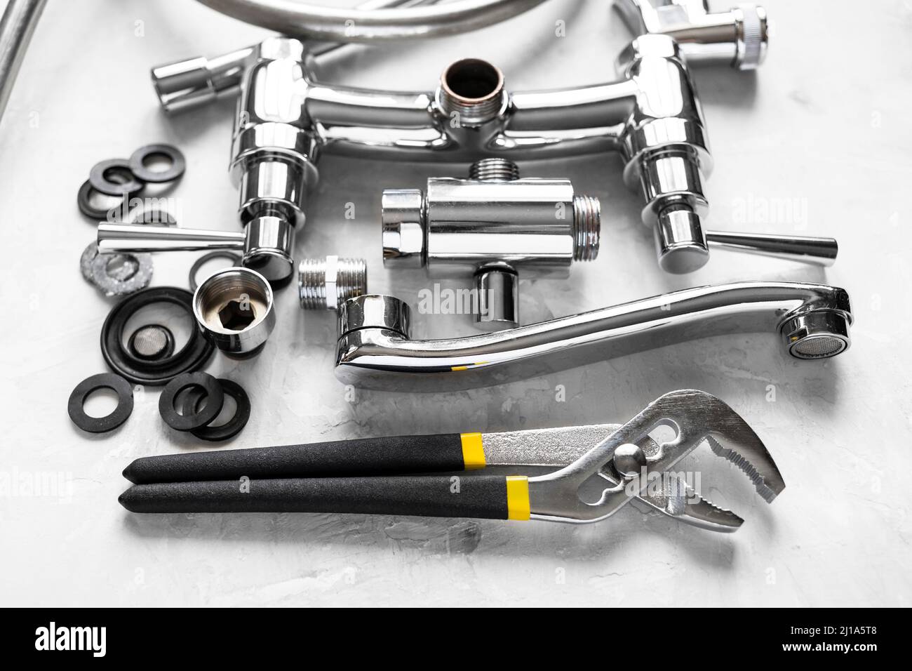 plumbing stilllife with wrench, disassembled spout, shower faucet