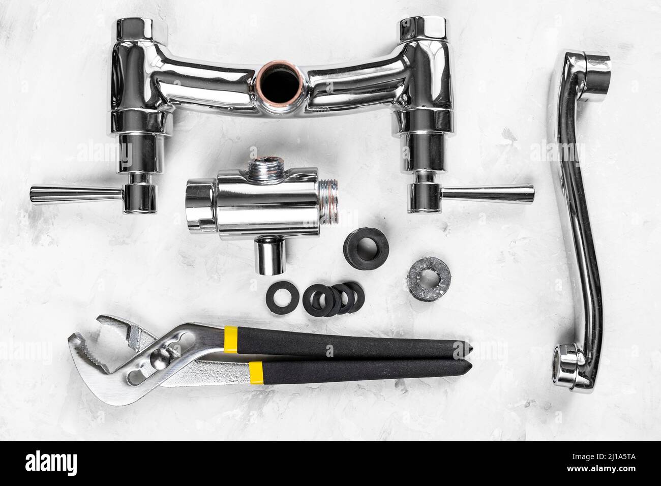plumbing background above view of wrench, disassembled shower faucet valve, diverter, spout