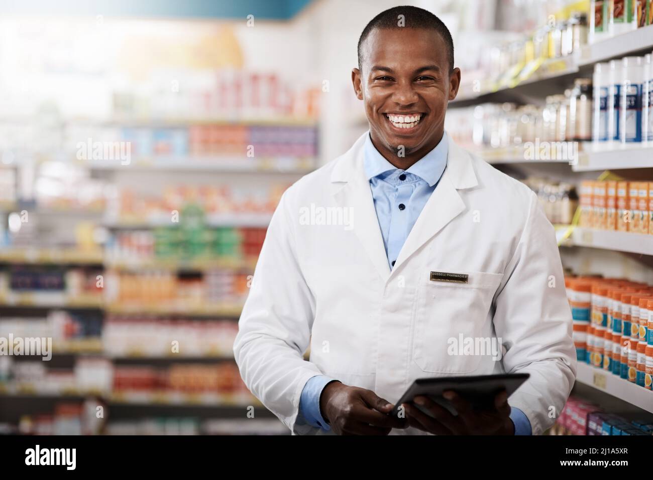 All our aisles are stocked full for your convenience. Portrait of a young pharmacist working in a chemist. Stock Photo