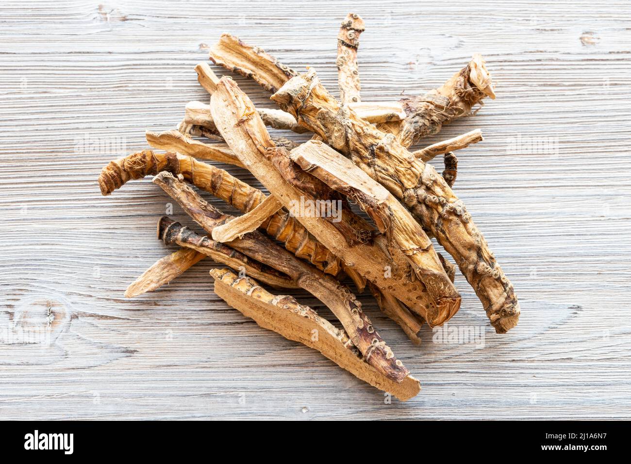 top view of pile of dried Sweet flag (calamus) roots on gray wooden table Stock Photo