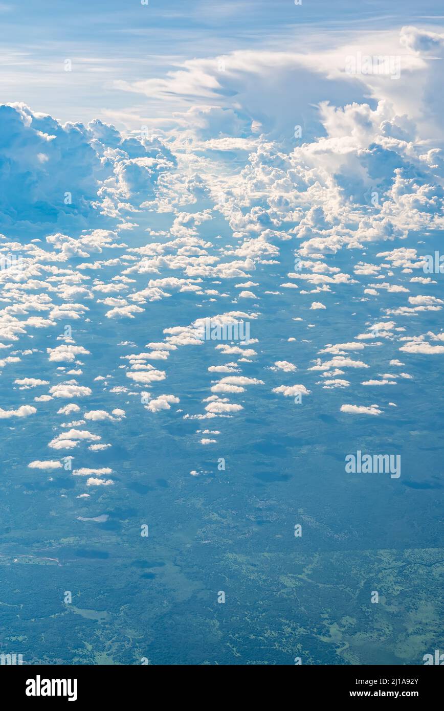 View over the clouds above Tanzania. Bright skyscape and green land beyond  Stock Photo - Alamy