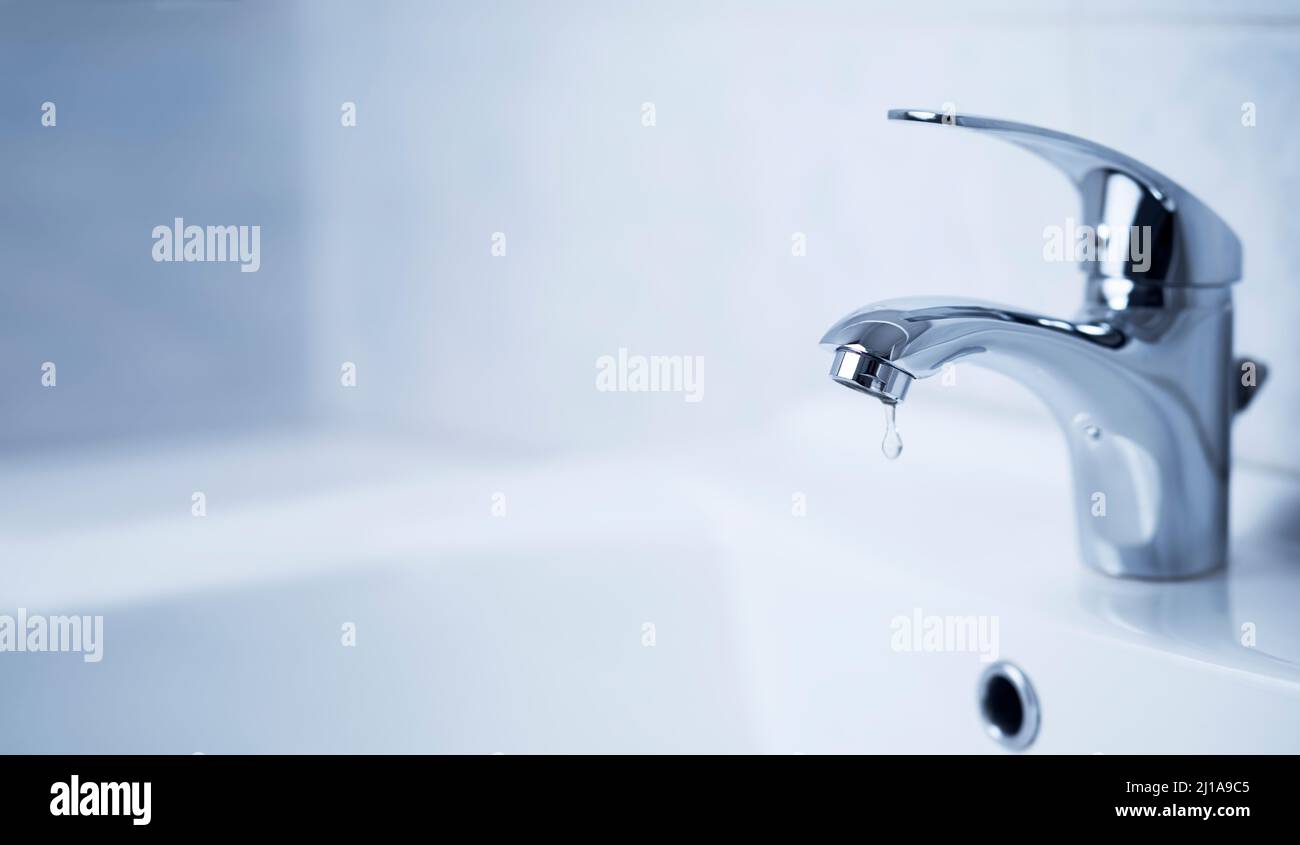 Water tap, stainless steel faucet. Drop drip in bathroom with sink