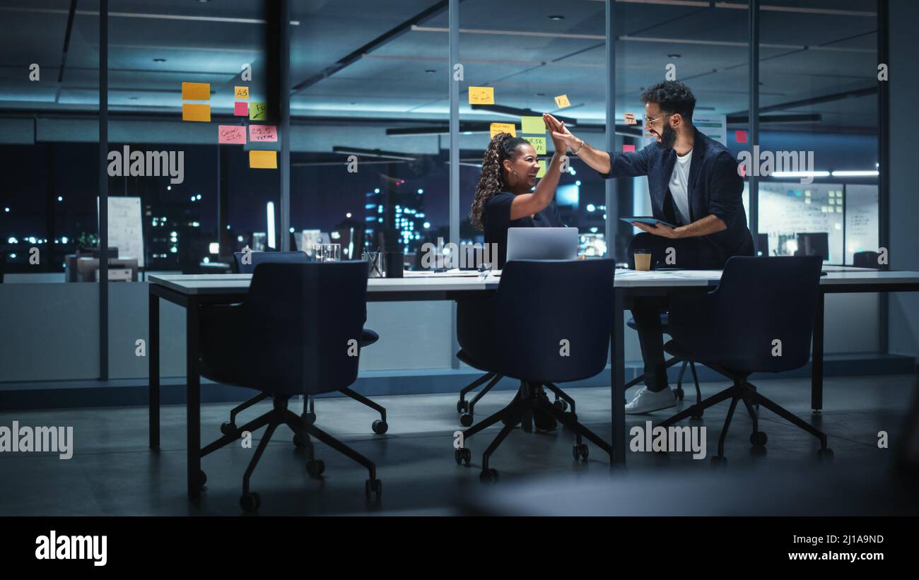 Businesspeople in Modern Office: Business Meeting of Two Managers. Female CEO and Art Director Talk; Discuss; Brainstorm and Agree on Corporate Brandi Stock Photo