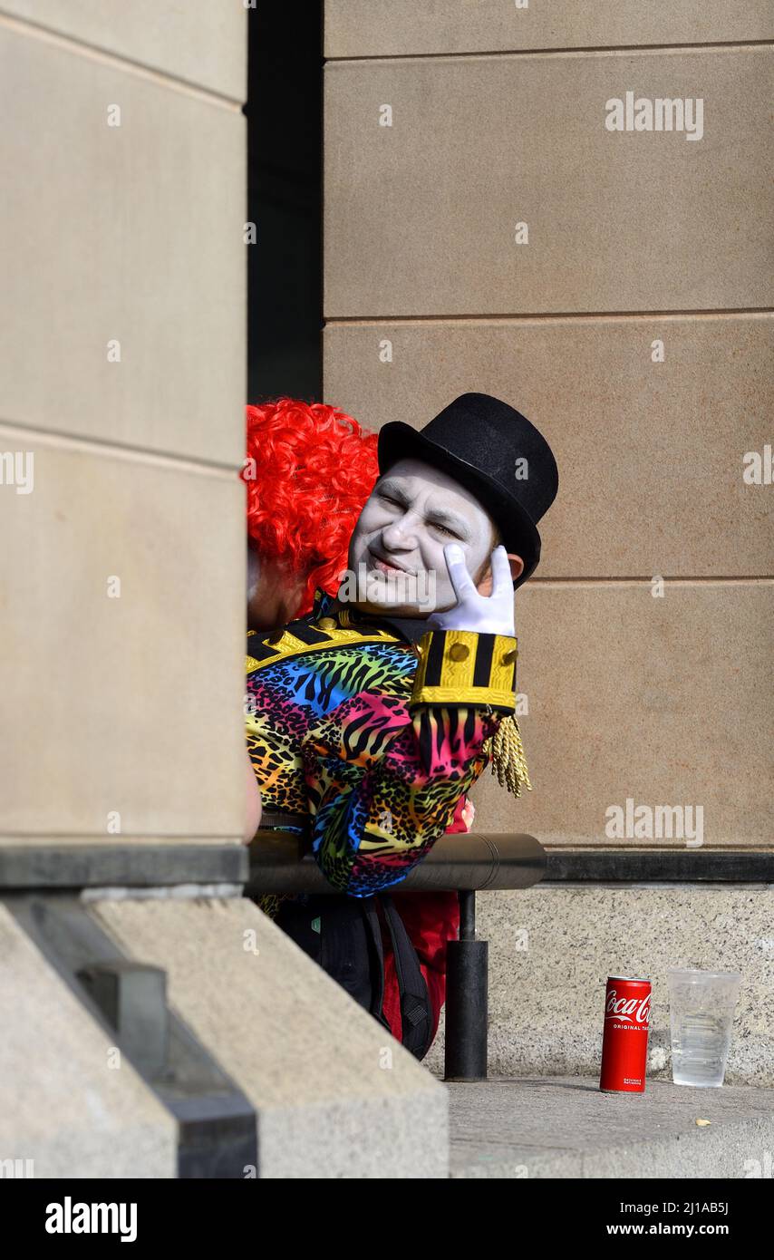 London, England, UK. Greeting from a colourfully dressed character outside Westminster Underground Station Stock Photo