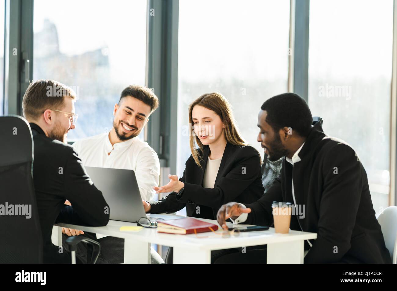 Group of young business partners have a meeting in the office sitting ...