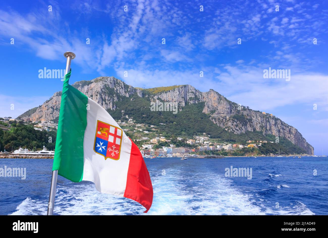Landscapes of the island of Capri from the sea. View of the coastline with Marina Grande town framed rocky shores and mountains. Stock Photo