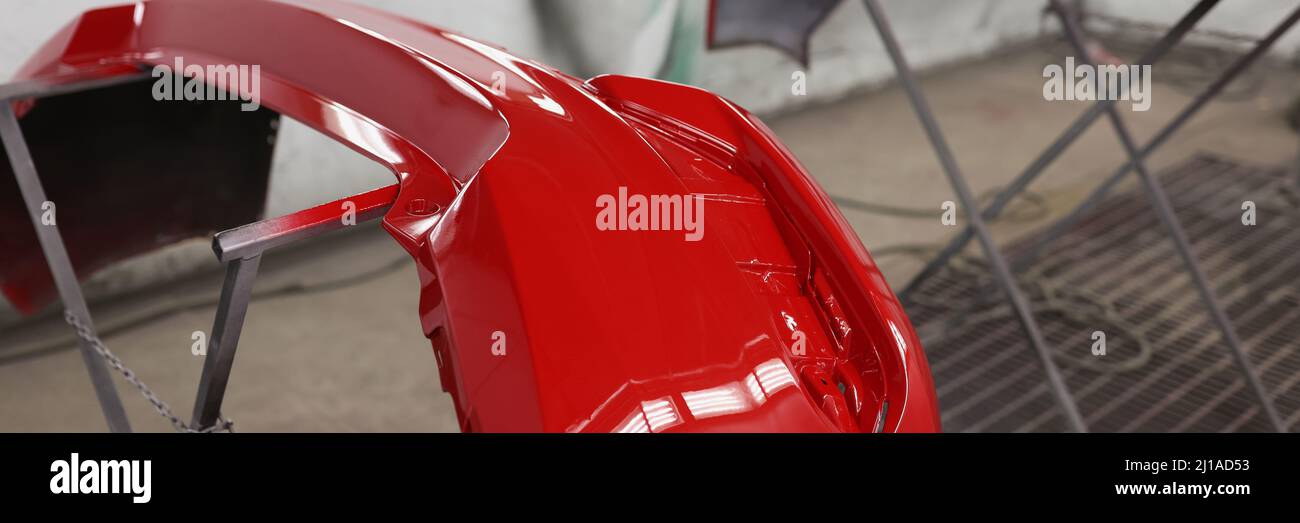 Painted red bumpers to drying in workshop closeup Stock Photo
