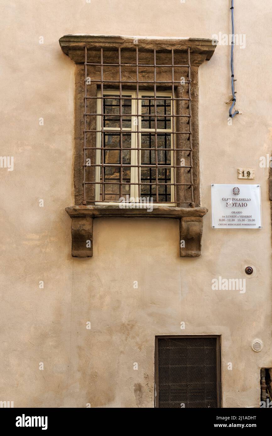 A vertical shot of the facade of a public notary office in Italy with a ...