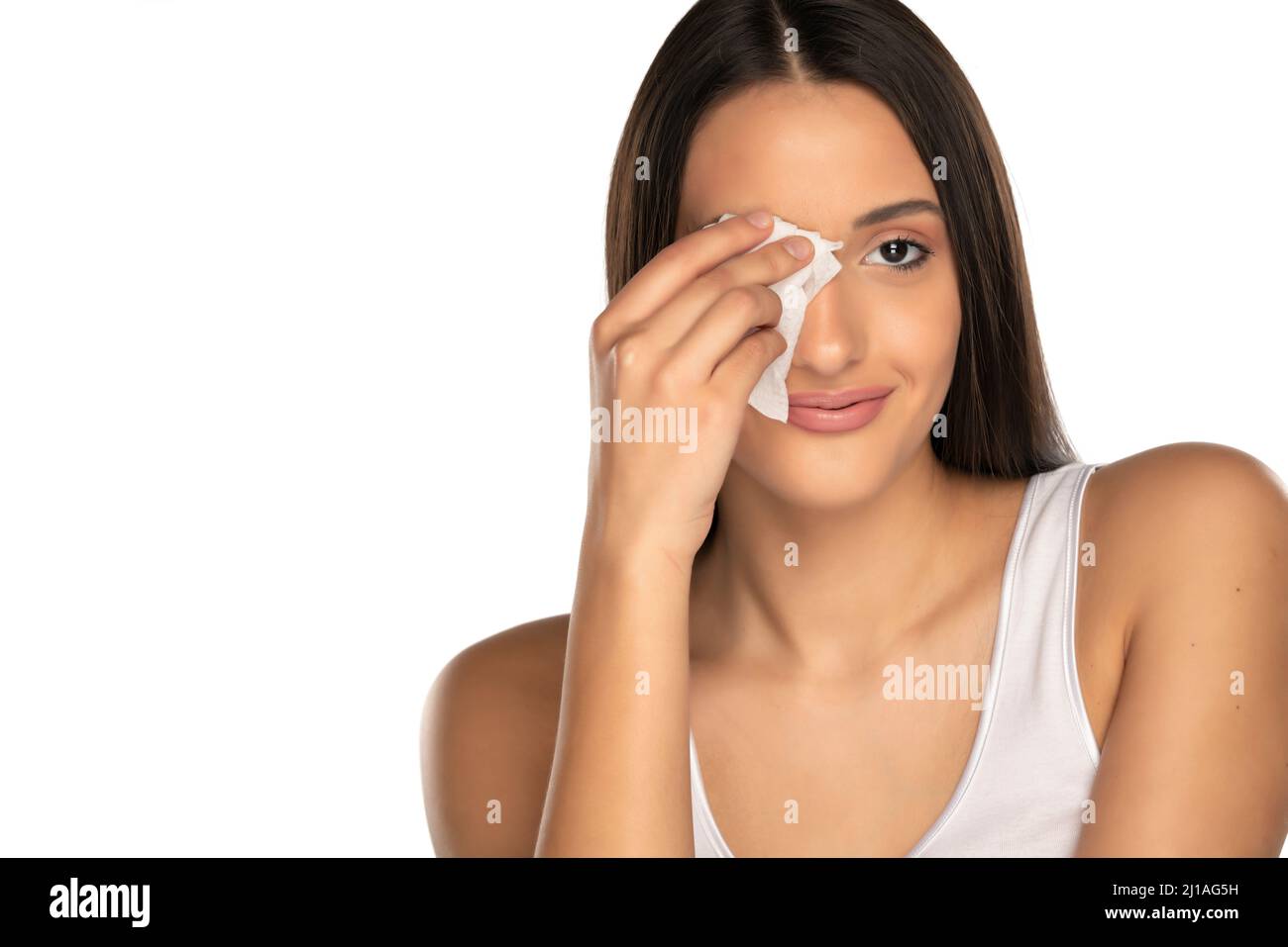 young smiling woman cleans her face with wet wipes on white background Stock Photo Alamy