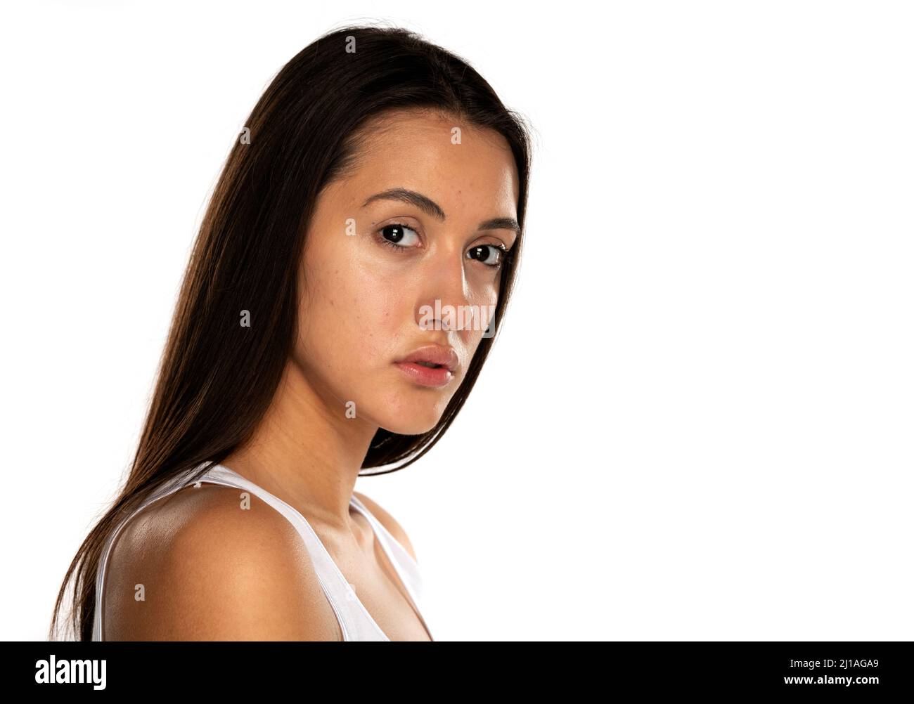 a young woman without makeup and long hair on a white background Stock Photo