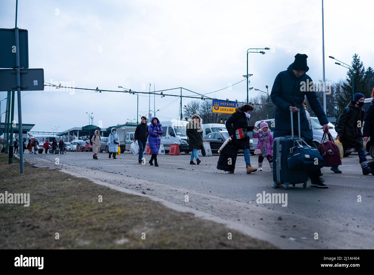 ukrainian refugees are seen entering Poland a border crossing between Poland and Ukraine as refugees flee the intensifying war in Ukraine, their home Stock Photo
