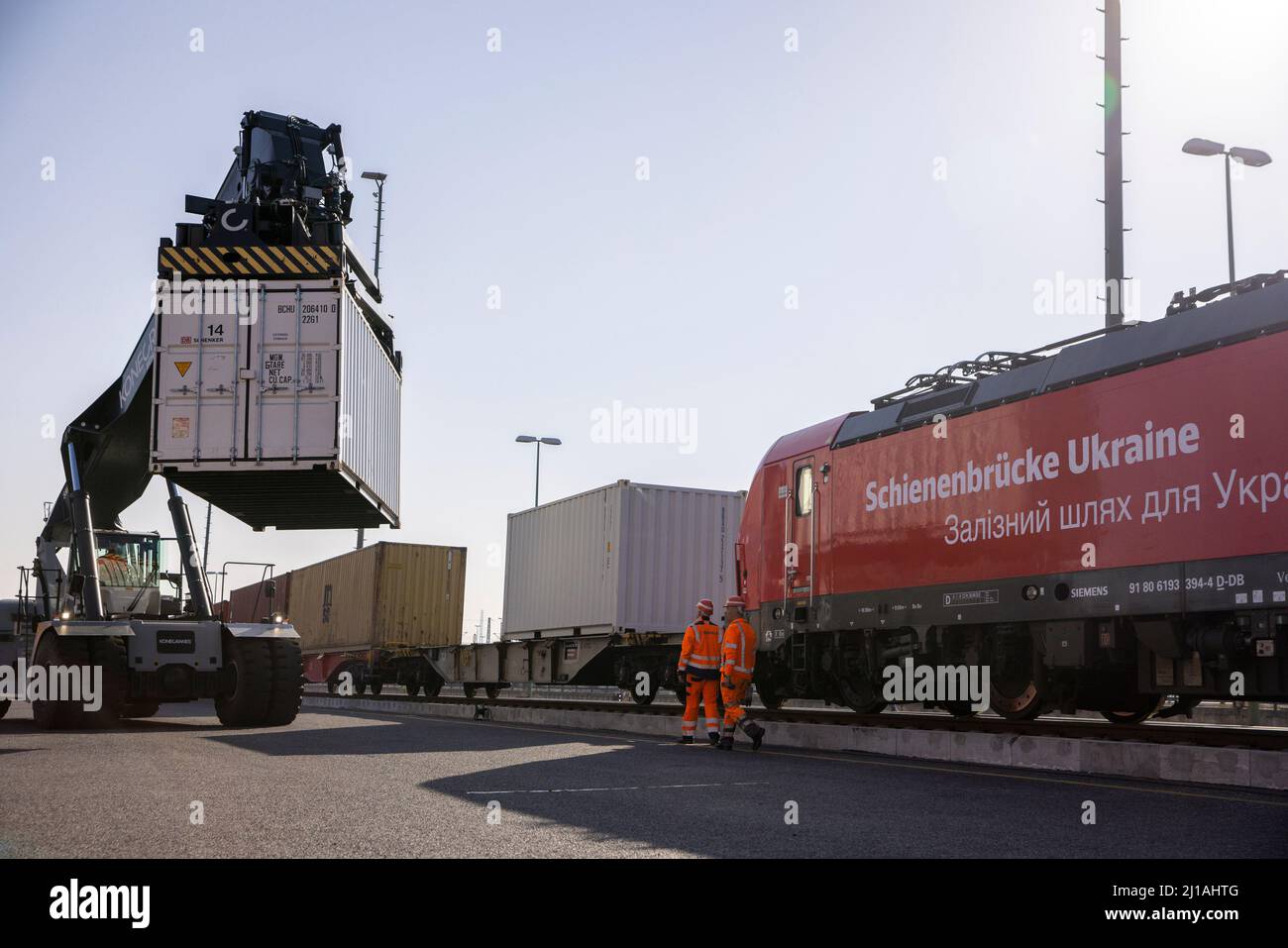 Berlin, Germany. 24th Mar, 2022. Workers load containers onto a train ...