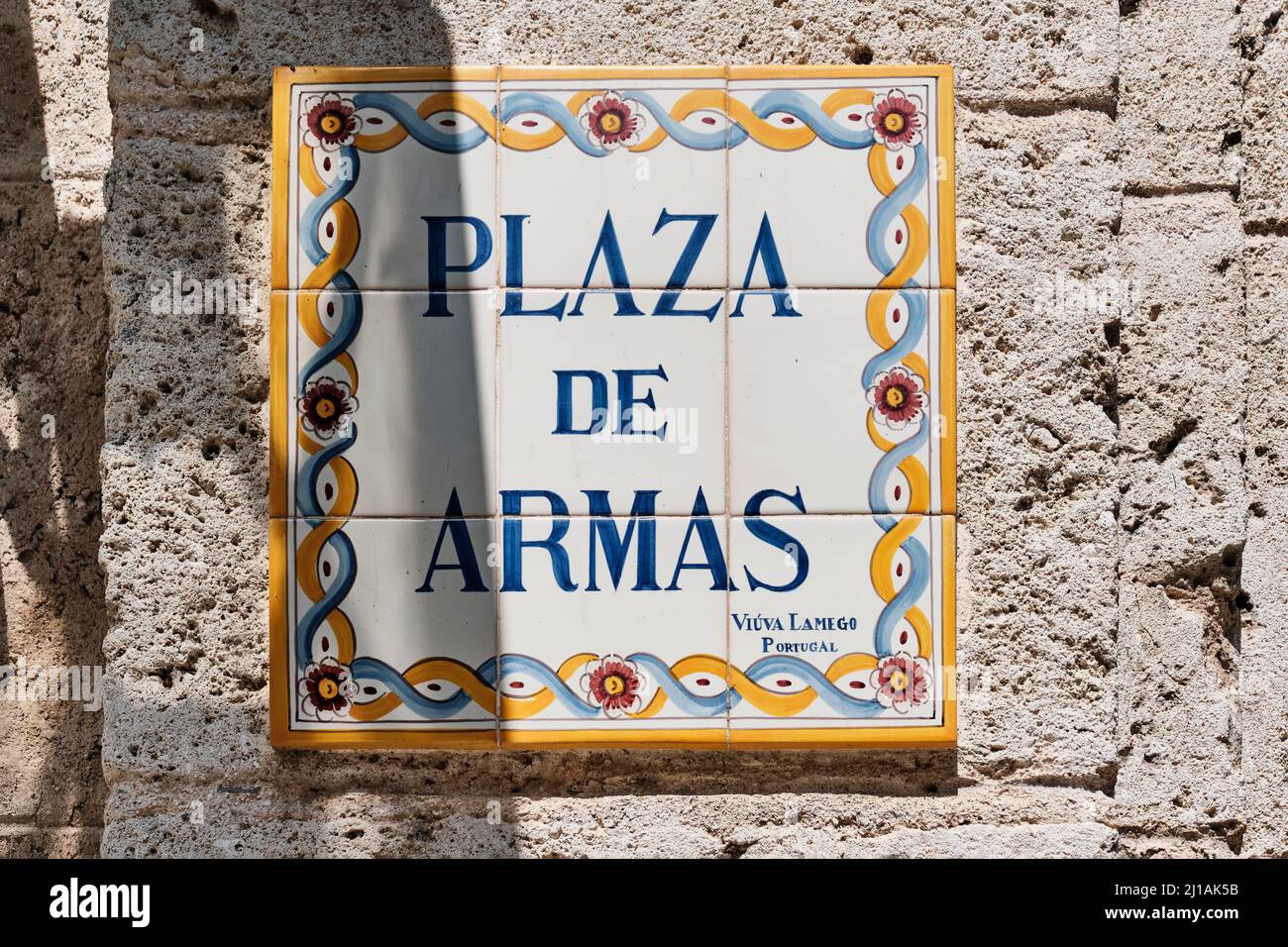 Colorful plaque with name of city square in Spanish. In English Armory