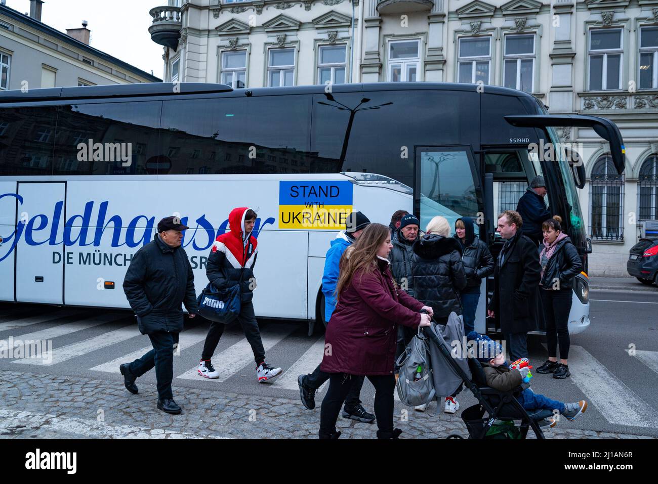 Ukrainian refugees board a bus to continue their journey from the border with Poland to other cities in Poland and Europe in Przemysil, Poland on Marc Stock Photo