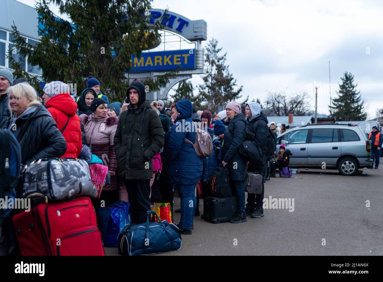 Refugees from Ukraine wait in line as they cross the Poland-Ukraine border fleeing the Russia-Ukraine war in Sheyni, Ukraine on March 8, 2022. More th Stock Photo