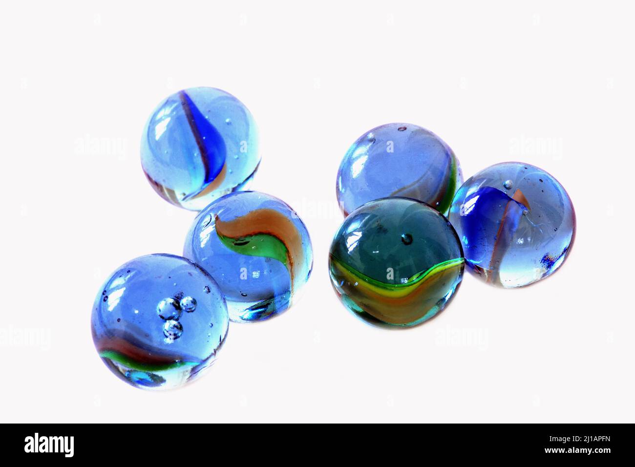 Six coloured glass children's marble toys Stock Photo Alamy