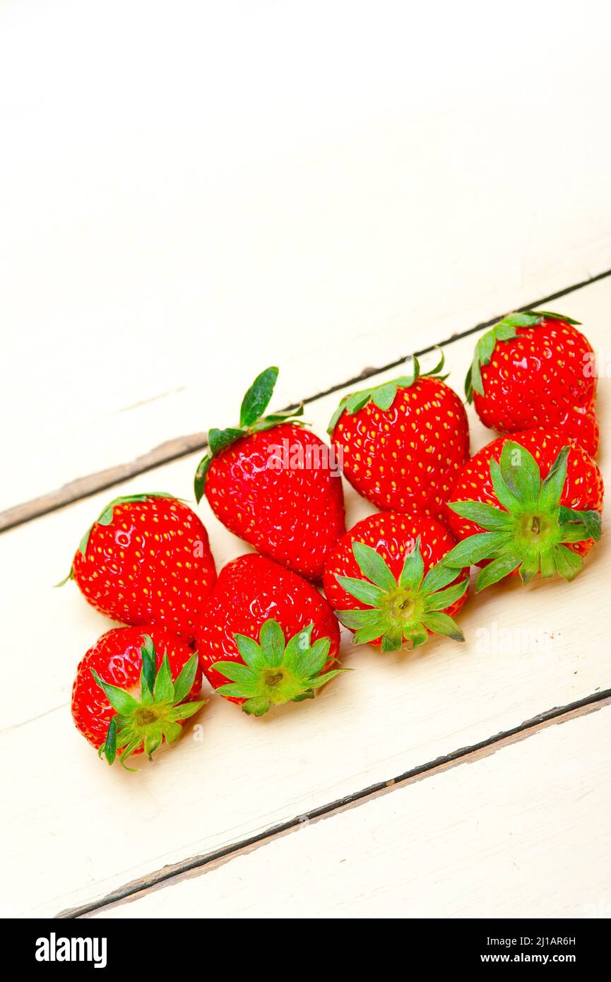 fresh organic strawberry over white rustic wood table Stock Photo - Alamy
