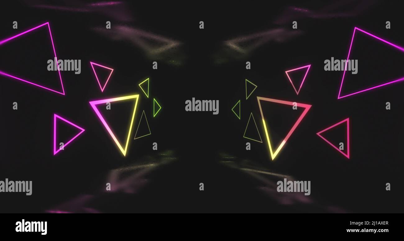 Image of pink and yellow neon light triangles flickering on black background Stock Photo