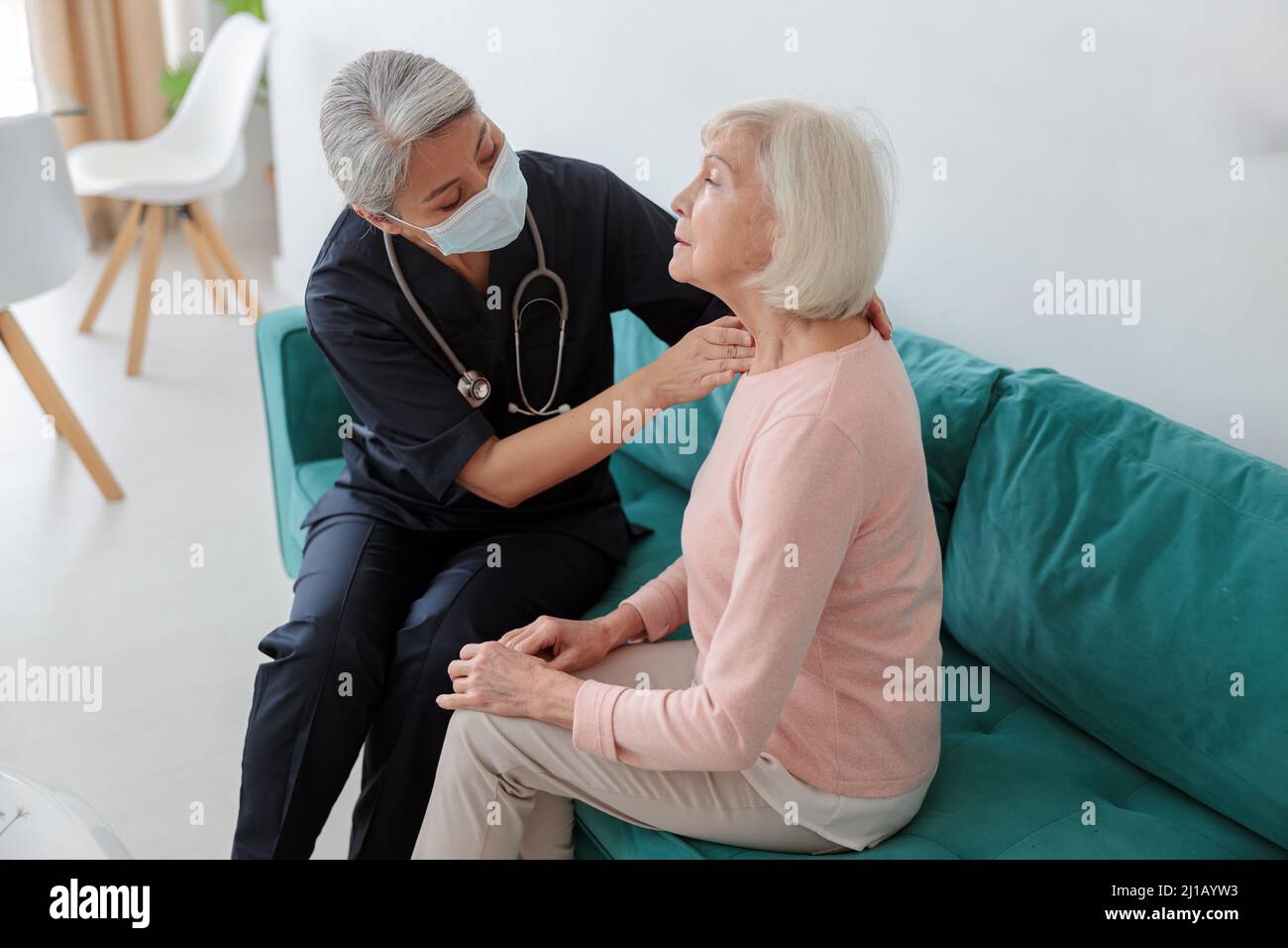 Medical practitioner searching for neck problems in a patient Stock Photo