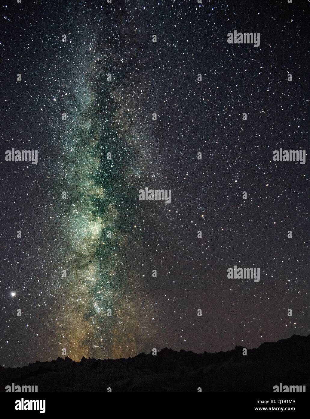 A vertical shot of the Milky Way starry sky over the nature Stock Photo ...