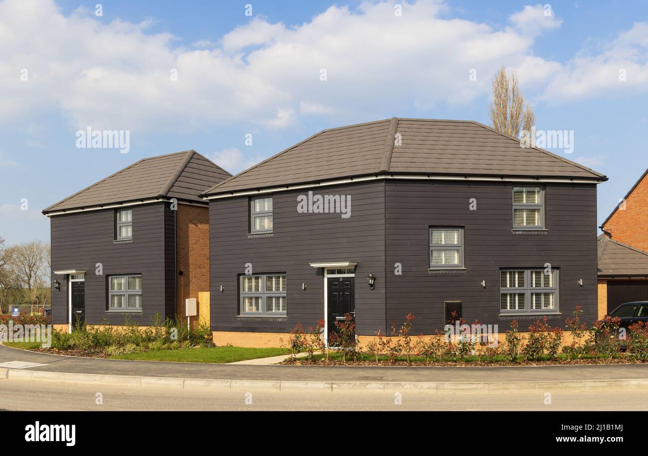 Detached new build home with black cladding at the David Wilson Homes Sawbridge Park housing development. hertfordshire. UK Stock Photo