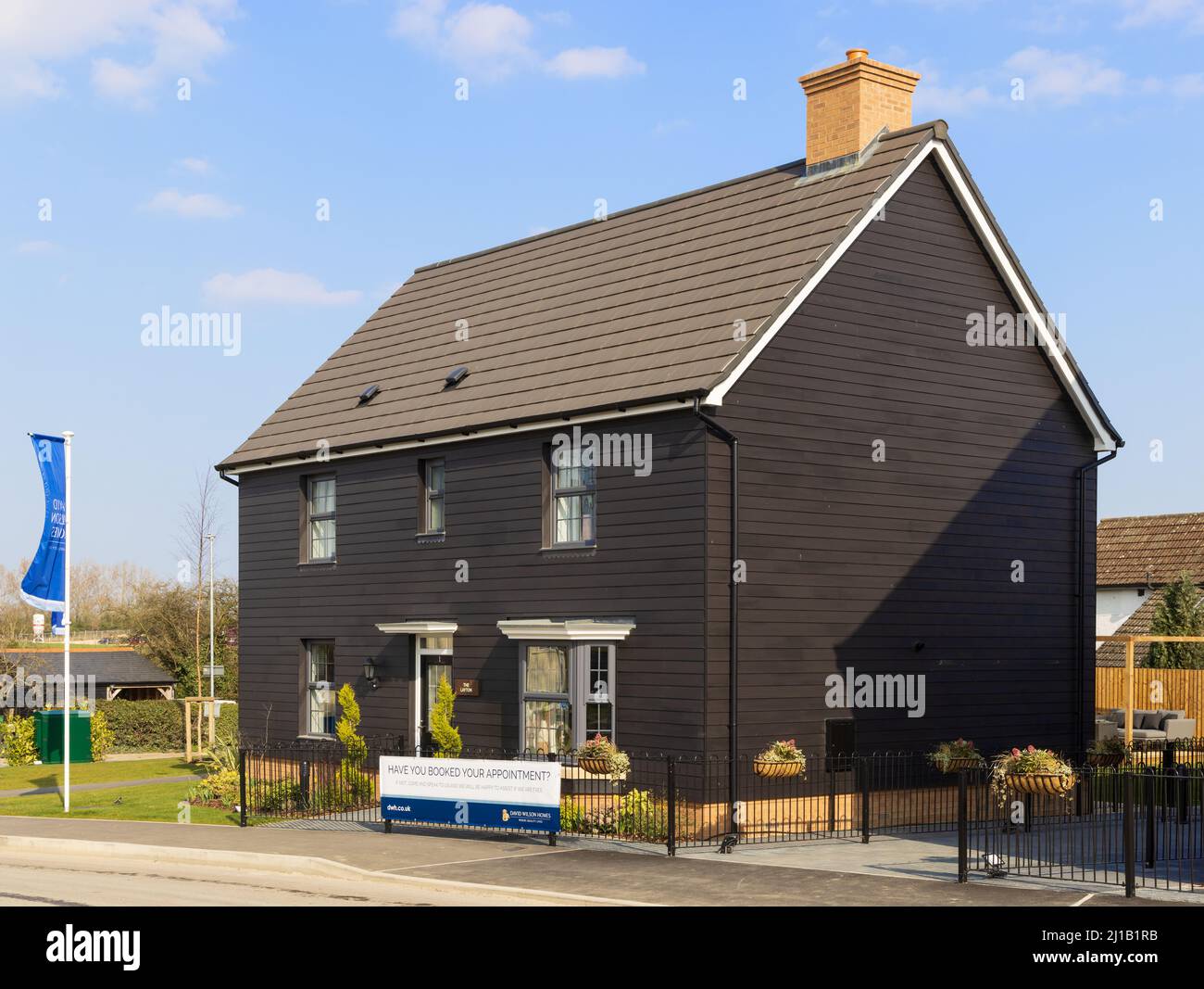 Detached new build home with black cladding at the David Wilson Homes Sawbridge Park housing development. hertfordshire. UK Stock Photo