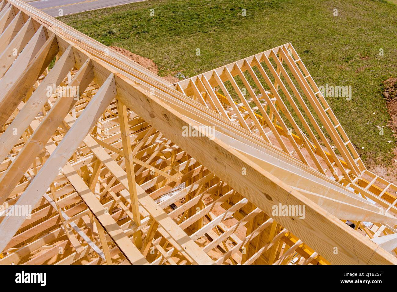 Aerial view the timber frame beam framework house stick built home under construction new build with wooden truss Stock Photo