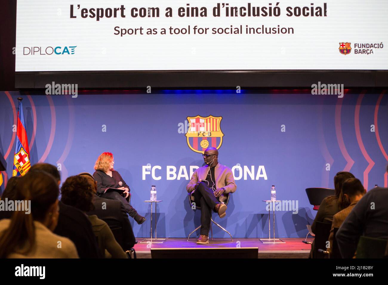 Lilian Thuram (C), former FC Barcelona player and founder of the Lilian Thuram Foundation for Education against Racism is seen speaking with Rita Marzoa (L), journalist and moderator of the FC Barcelona event, 'Sport as a tool for social inclusion”. The Public Diplomacy Council of Catalonia, DIPLOCAT and the FC Barcelona Foundation have organized an event on sport as a tool for social inclusion, being opened with a talk with Lilian Thuram, former French FC Barcelona player and creator of the Lilian Thuram Foundation for Education against Racism, who spoke about education and racism in the cont Stock Photo